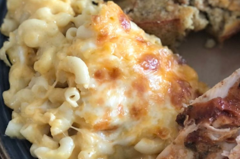 Plated creamy macaroni and cheese as a side dish.